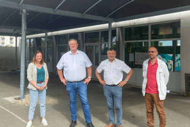 3 hommes et une femme qui posent sous le préau d'une école. Au centre, le Maire de Guipavas, M. Fabrice JACOB.